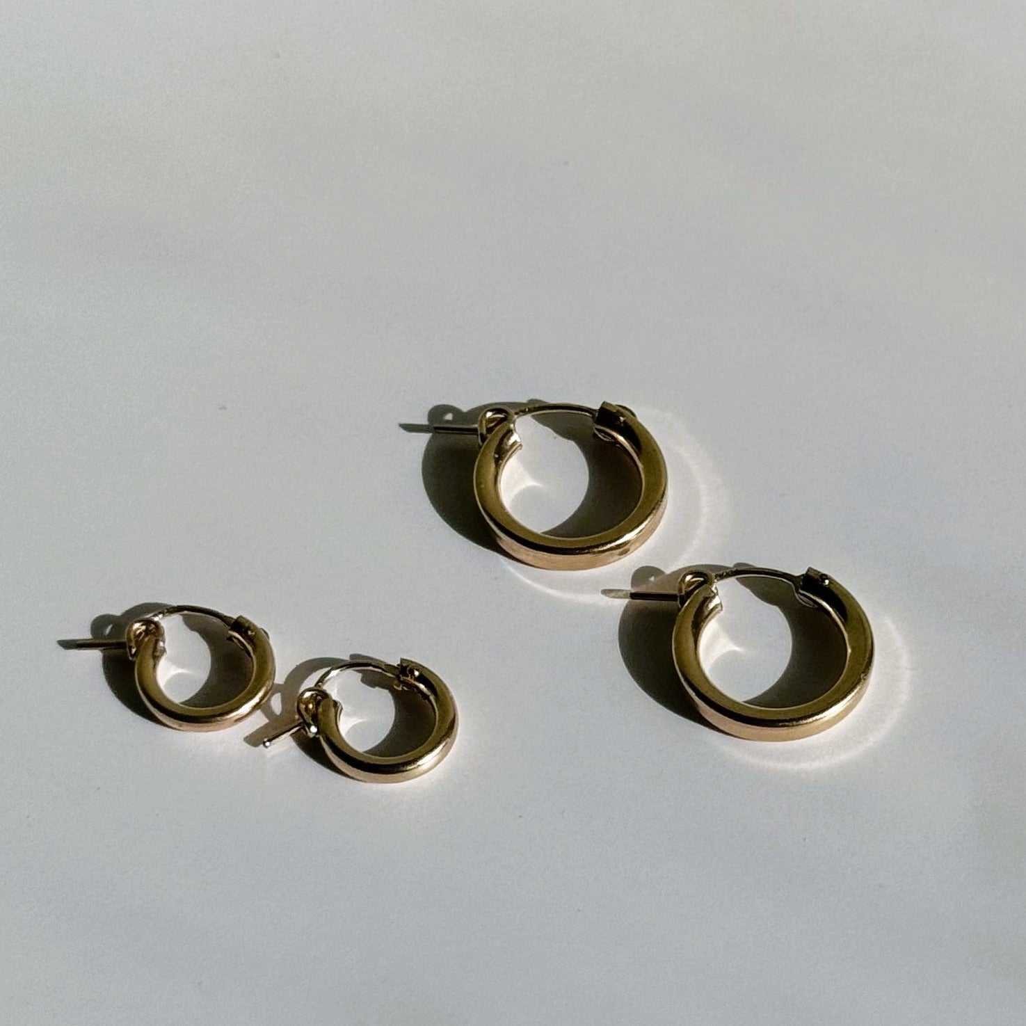 small and medium hoop earrings in gold